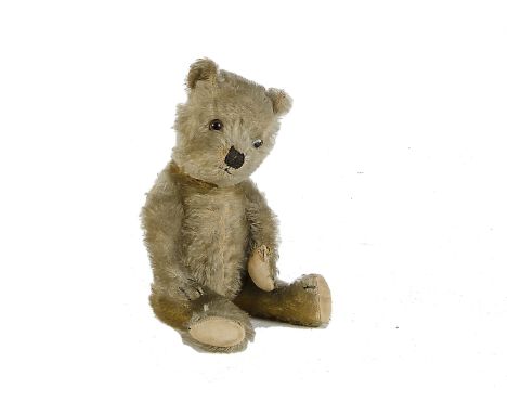 A Chiltern type Teddy Bear, 1930s, with golden mohair, clear and black glass eyes with brown painted backs, black stitched no