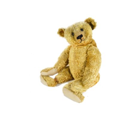 A large early Steiff centre - seam Teddy Bear, circa 1910, with golden mohair, black boot button eyes, pronounced clipped muz