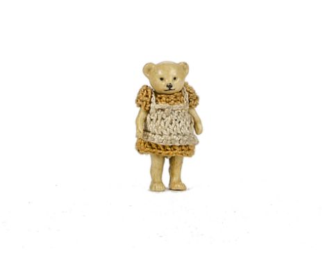 A Hertwig all - bisque girl Teddy Bear, 1910-20s, with pin - joints and yellow crochet dress - 1¾in. (4.5cm.) high