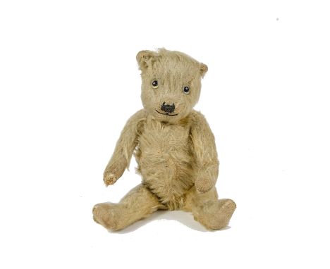 A small Chiltern - type Teddy Bear, 1930s, with golden mohair, clear and black glass eyes with remains of brown painted backs