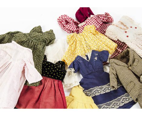 A quantity of clothes for small dolls: including a boys two piece brown patterned wool suit; several dresses; and a red wool 