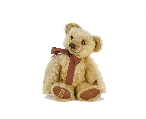 A Merrythought Teddy Bear, 1920s, with golden mohair, orange and black glass eyes, pronounced clipped muzzle, black stitched 