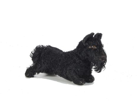 A 1930s Steiff standing Scotty Dog, with black mohair, brown, black and white elliptical eyes, black stitched nose and mouth,