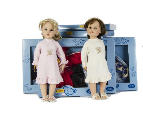 Two Götz for Steiff vinyl dolls, one with blonde and one brown hair, each in a nightdress with Teddy Bear motif, in original 