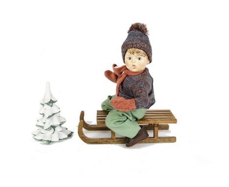 A Goebels Hummel Doll Ride into Christmas, a china head doll with sledge and china fur tree, in original box, 1991 - 11¾in. (