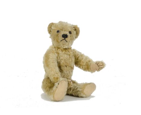 A Farnell Teddy Bear, 1920s, with golden mohair, clear and black glass eyes with brown painted backs, pronounced clipped muzz