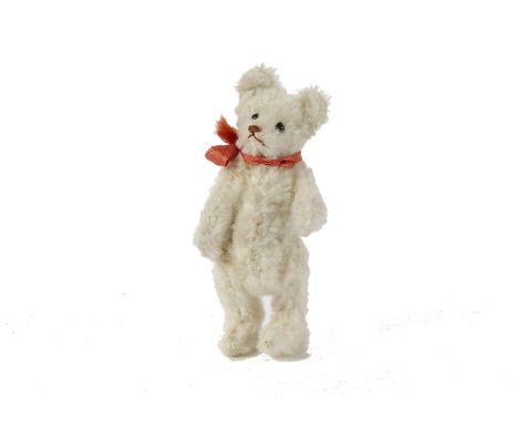 A rare Steiff miniature white mohair Teddy Bear, 1920s, with brown stitched nose and mouth, swivel head, jointed limbs and sl