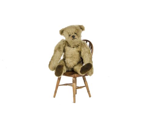 A small Steiff Teddy Bear, circa 1913, with pale golden mohair, black boot button eyes, pronounced clipped muzzle, black stit