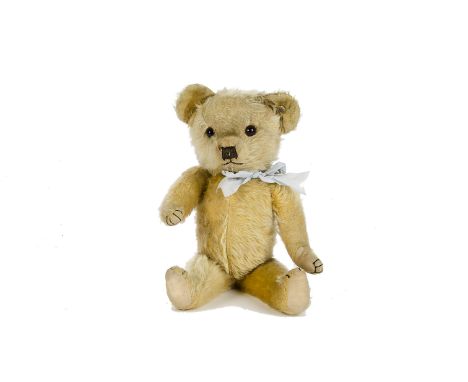 A Merrythought Teddy Bear, 1930-40s, with golden mohair, orange and black glass eyes, black stitched nose, mouth, webbed hand