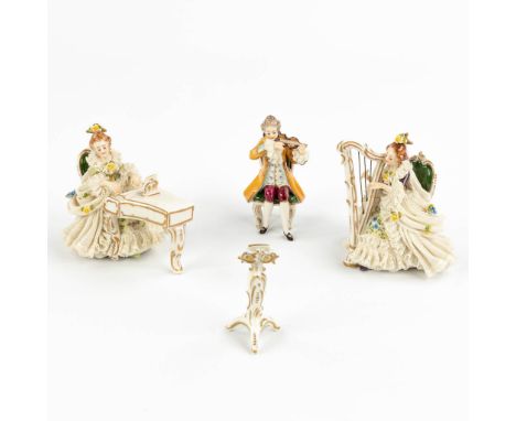 A vintage porcelain orchestra, consisting of a piano player, violin player and harp player, with a partiture stand. Finished 