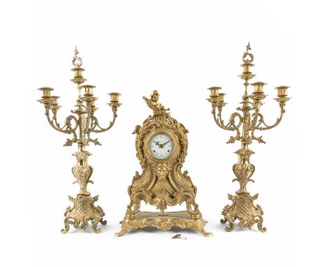 A three-piece mantle garniture clock and candelabra, made of bronze by Imperial. CircaÊ1970. Height candelabra: 69 cm. (18 x 