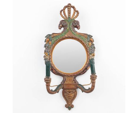 A wall lamp with mirror and ram's heads, made of sculptured and patinated wood in Italy. 20th century. (31 x 65cm)