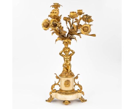 A candelabra made of white marble, mounted with gilt bronze in Louis XVI style. Decorated with a putto, 19th century. (24 x 3