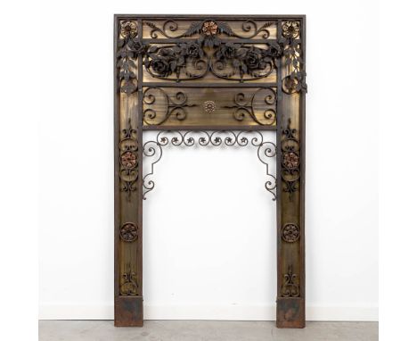 A fireplace interior made of bronze and wrought iron. Circa 1900. (81 x 133cm)