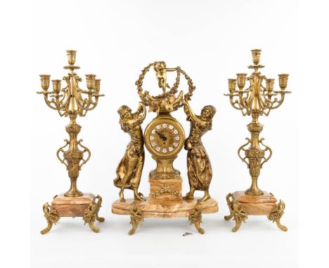 A three-piece mantle garniture clock and candelabra, made of bronze and onyx. The second half of the 20th century. Candelabra