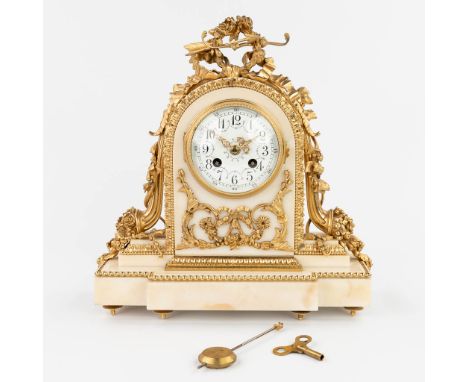 A table clock made of white marble mounted with gold-plated bronze in Louis XVI style. The second half of the 19th century. A