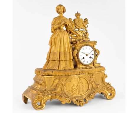 An antique mantle clock made of gilt spelter, with an image of a lady with a heraldic sign 'Union Fait La Force'. Made in Fra