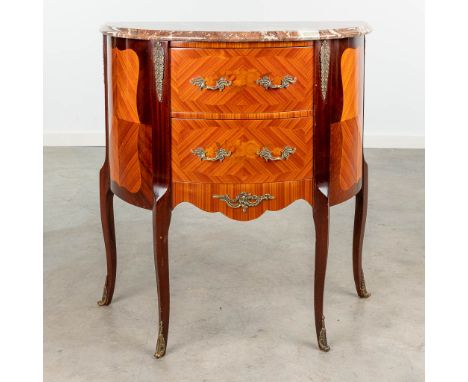 A small demi-lune commode chest of drawers, decorated with marquetry inlay and mounted with bronze and marble. Around 1970. (