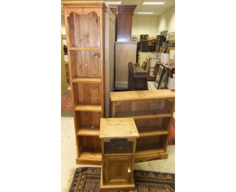 A narrow pine open five shelf bookcase, a pine open three-shelf bookcase and a pine bedside cabinet with open shelf above sin