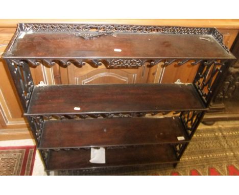 A Chippendale style mahogany four tier wall shelf