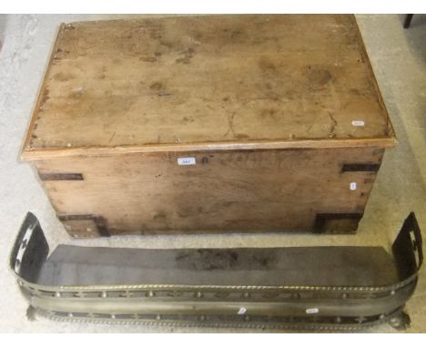 A Victorian pine trunk, and a pierced brass fender