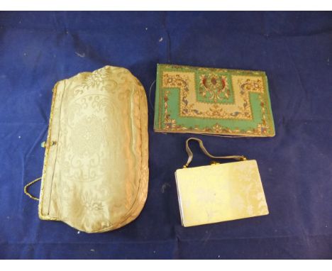 An early 20th Century silk evening bag with enamelled decorated gilt metal clasp, an early 20th Century embroidered purse, an