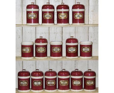 A set of fifteen Victorian pottery chemist's drug jars, each with puce ground, with domed lids, bearing labels to include "Ca