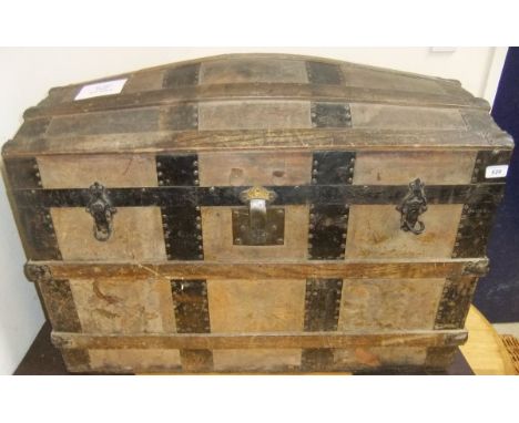 A Victorian leather and strapwork bound dome top trunk with fitted interior, bearing label inscribed "Whiteways, Laidlaw & Co