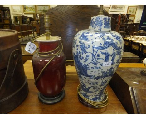 A Chinese sang de boeuf barrel bodied vase converted to a table lamp, on hardwood stand, together with a Chinese blue and whi