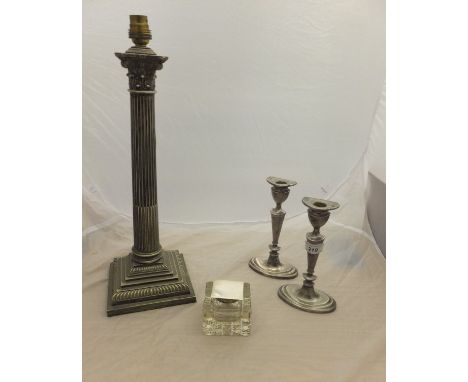 A silver plated Corinthian column table lamp and pair of white metal candlesticks and a silver mounted cut glass inkwell (Lon