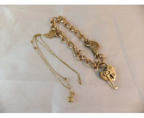 A 9ct gold bracelet with a heart shaped lock and various charms and a 9ct gold necklace CONDITION REPORTS Some general wear a