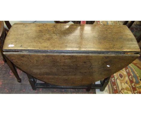 An 18th Century oak oval gate-leg drop-leaf dining table on turned supports to block feet united by stretchers CONDITION REPO