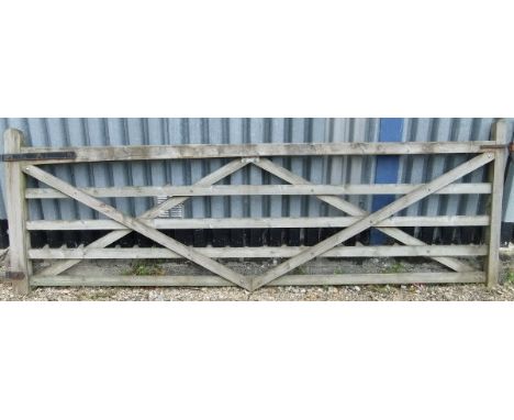 A large wooden farm gate CONDITION REPORTS Gate overall with weathering and chips and various splits.  Size approx 122 cm hig