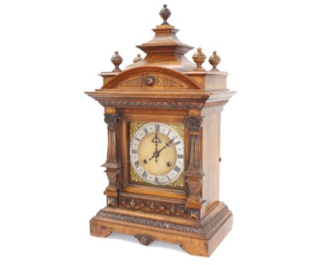 German walnut two train mantel clock striking on a gong, the 6" square brass dial with silvered chapter ring enclosing a matt