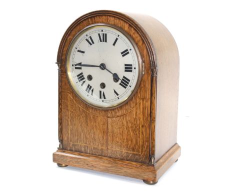 Oak three train mantel clock striking on five rods, the 6.5" silvered dial within a rounded arched case inlaid with boxwood l