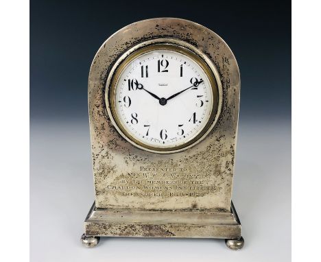 A George V silver table / boudoir clock, having a Borne case with engraved Women's Institute / WI presentation, a white ename