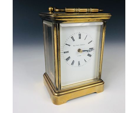 A 20th century Matthew Norman of London brass cased carriage clock, having a white-enamelled dial, Roman numerals and cornich