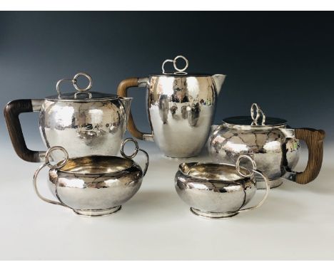 A George V Scottish Arts and Crafts silver five-piece tea and coffee service by Sybil Norah Pringle, each with planished deco