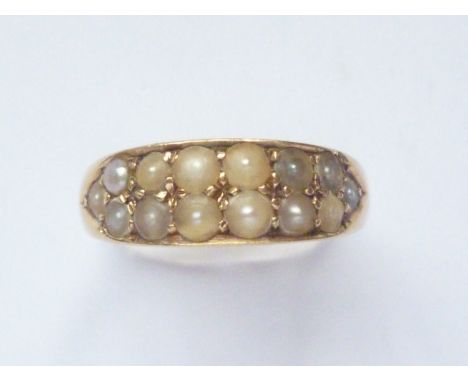 A Victorian 18ct gold and pearl dress ring, the lenticular face sunken and pellet set with black and white pearls, 3.2g