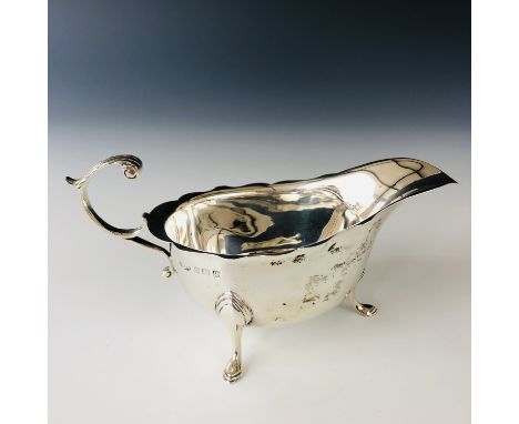 A George V silver sauce boat, of helmet form with a flying scroll handle, James Woods and Sons, Birmingham, 1915, 97.7g