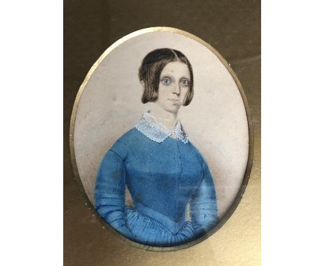(19th century) Three quarter length portrait of a young lady in a blue silk dress and lace collar, framed and mounted under g
