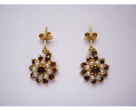 A vintage pair of garnet and pearl ear pendants, in a flower head cluster arrangement, on yellow-metal, tests as high-carat g