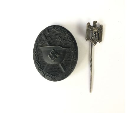 A German Third Reich black wound badge, numbered 65 verso, together with a Wehrmacht stick pin