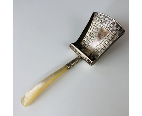 A Georgian silver caddy spoon, in the form of a shovel, with engraved chequered decoration to the bowl, and a mother of pearl