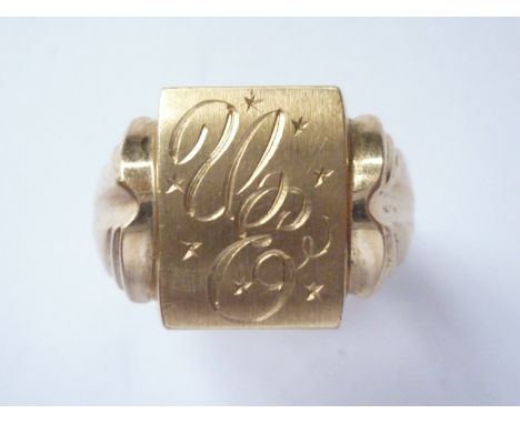 A yellow-metal signet ring, the rectangular face being engraved with a monogram, held within shaped shoulders, stamped '10K',