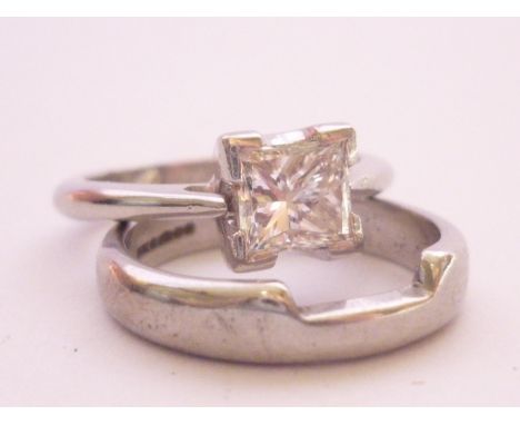 A contemporary platinum and princess-cut diamond solitaire ring and matching wedding band, the diamond of approximately 1ct, 