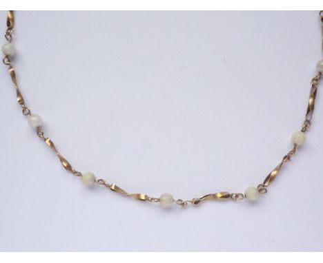 A 1930s 9ct gold and pearl necklace, comprising twisted lemniscate links interspersed by pearls, 9.7g
