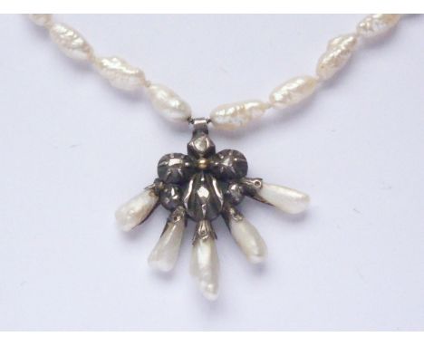 A Georgian white-metal, diamond and baroque pearl pendant necklace, with pansy-shaped flower-head pendant pinch-set with old 