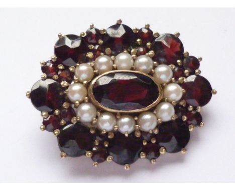 A vintage 9ct gold, garnet and pearl brooch, in a flower-head cluster arrangement, with central oval-cut and collet-set garne