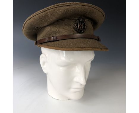A Great War army officer's Service Dress cap by Cater &amp; Co of Pall Mall, the peak trimmed in leather, bearing Royal Horse